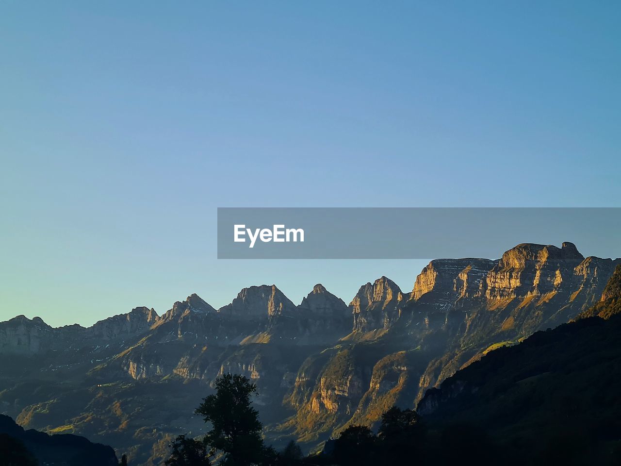 SCENIC VIEW OF MOUNTAINS AGAINST BLUE SKY