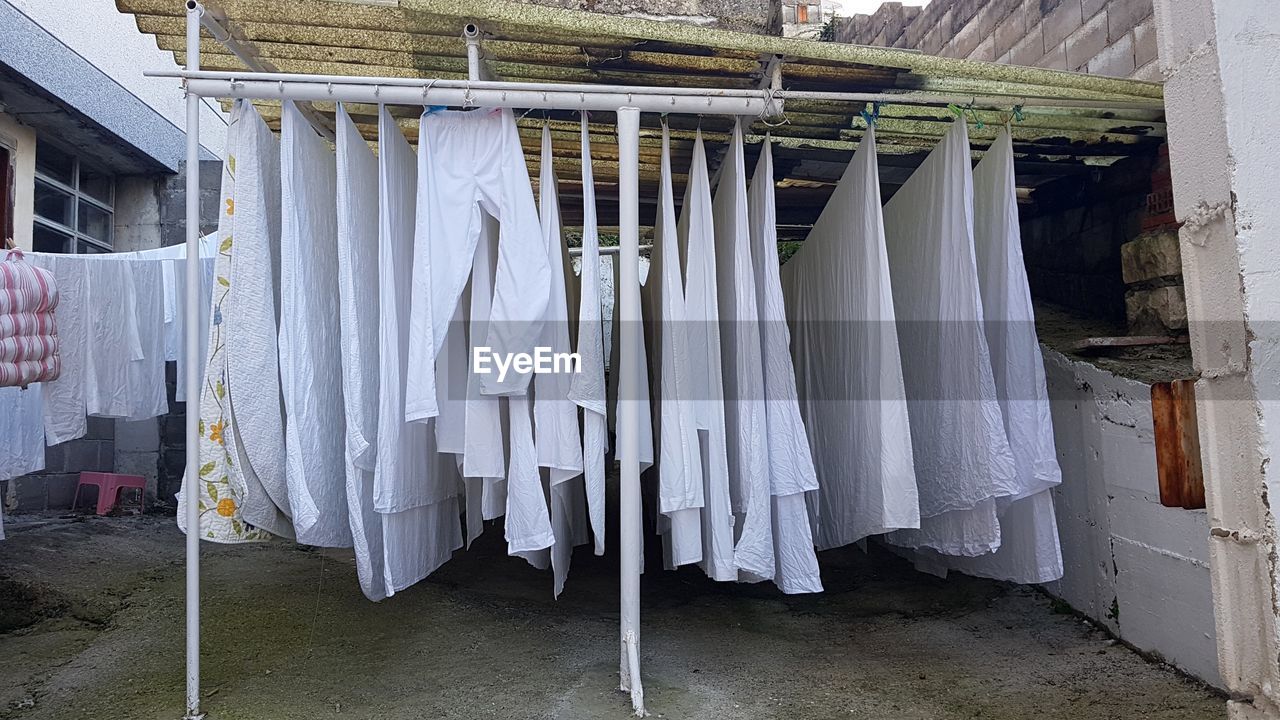 Clothes drying on clothesline against building