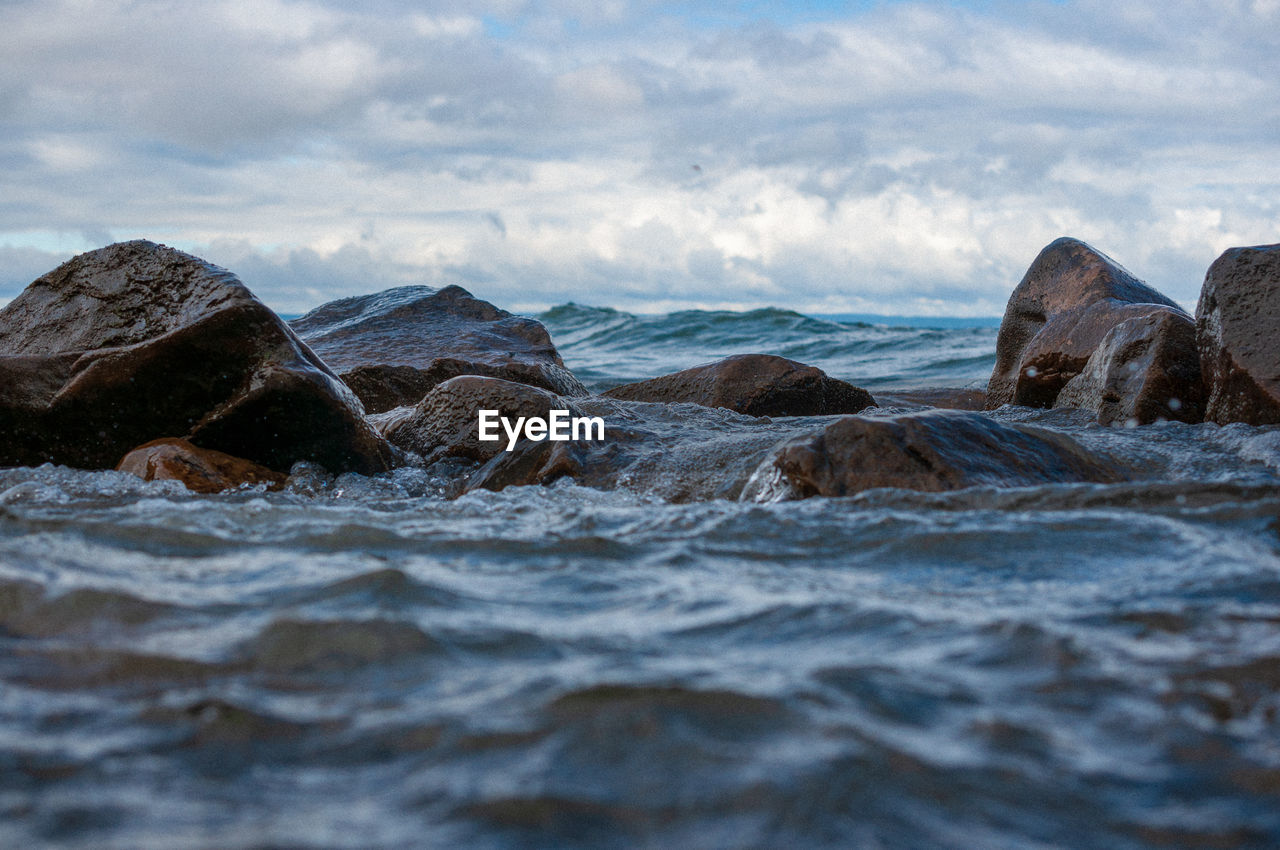 Rocks on beach against sky