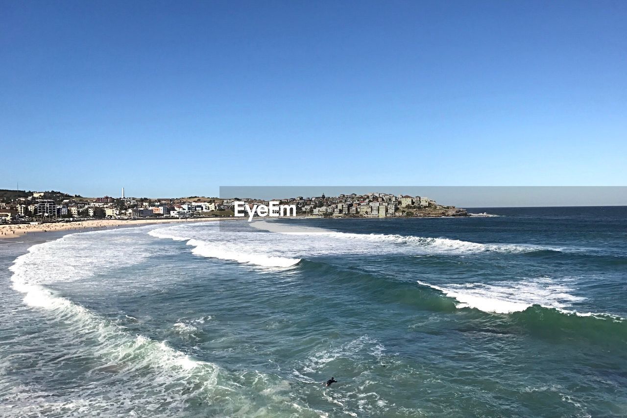 Scenic view of sea against clear blue sky