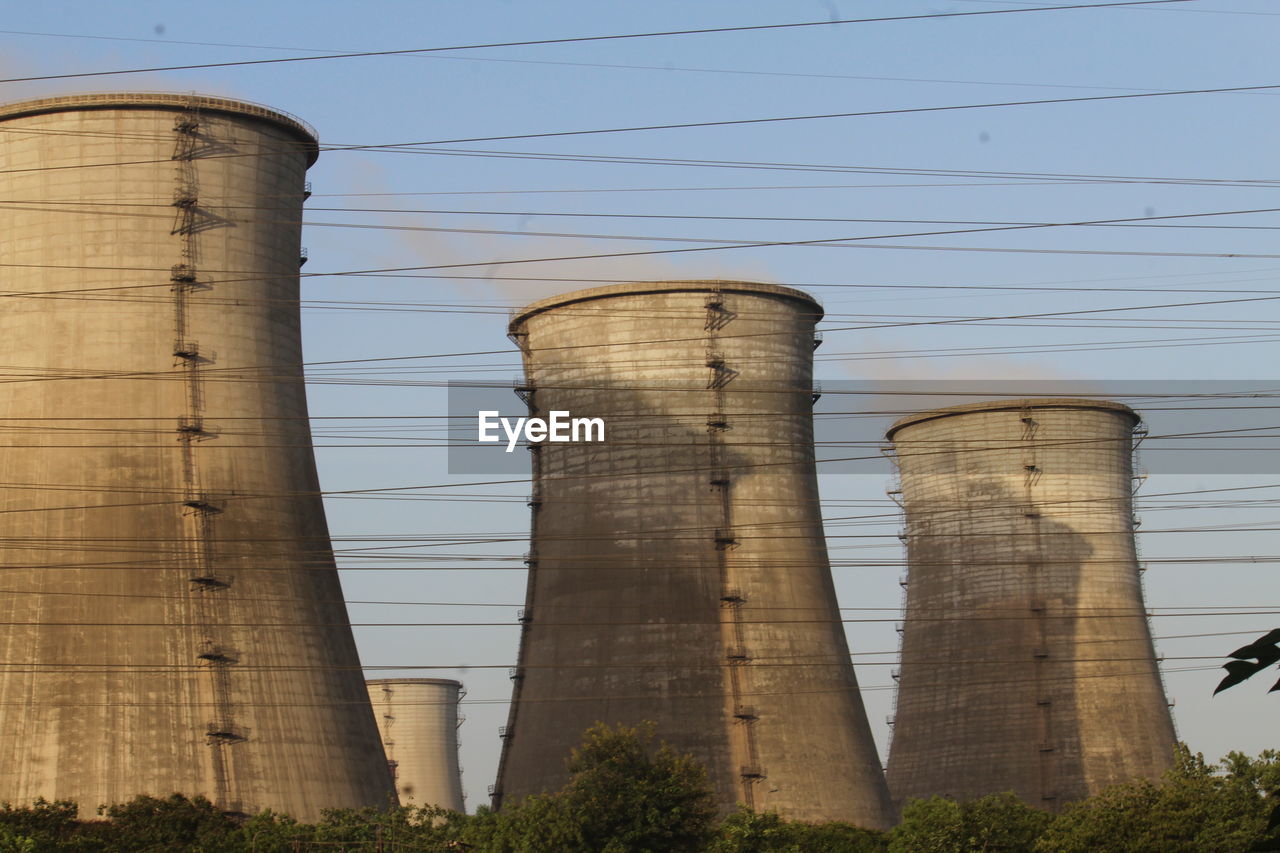 Low angle view of smoke stack against sky