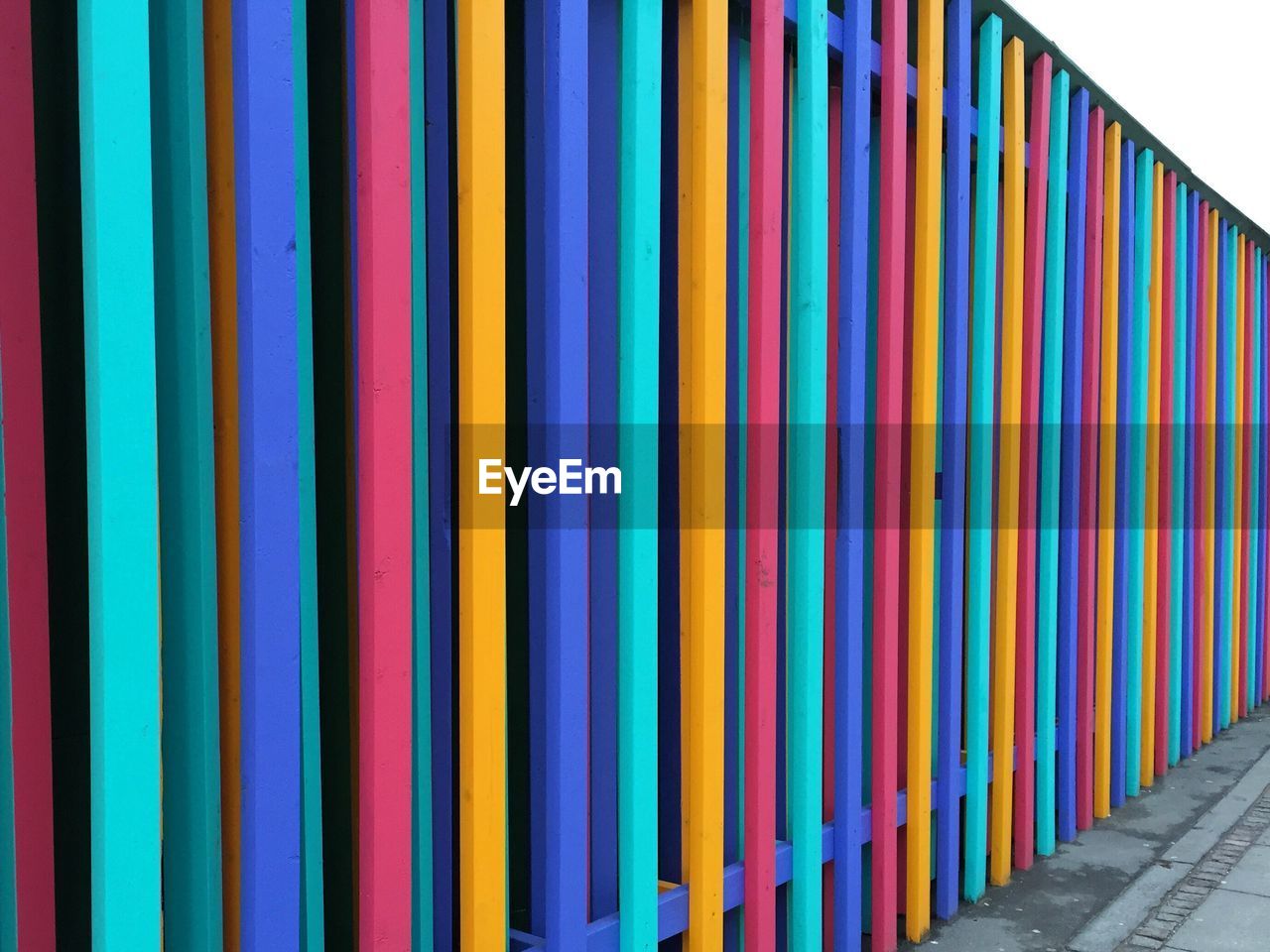 Colorful fence on sunny day