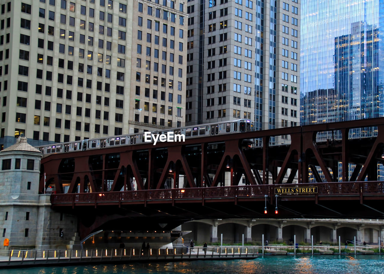 Low angle view of bridge over river in city