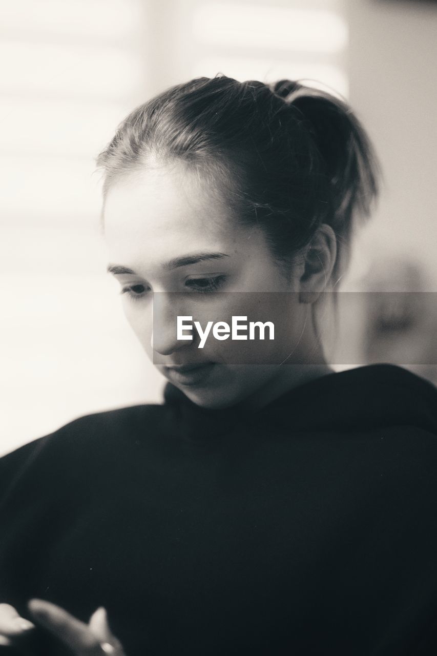 Close-up portrait of a young woman at home