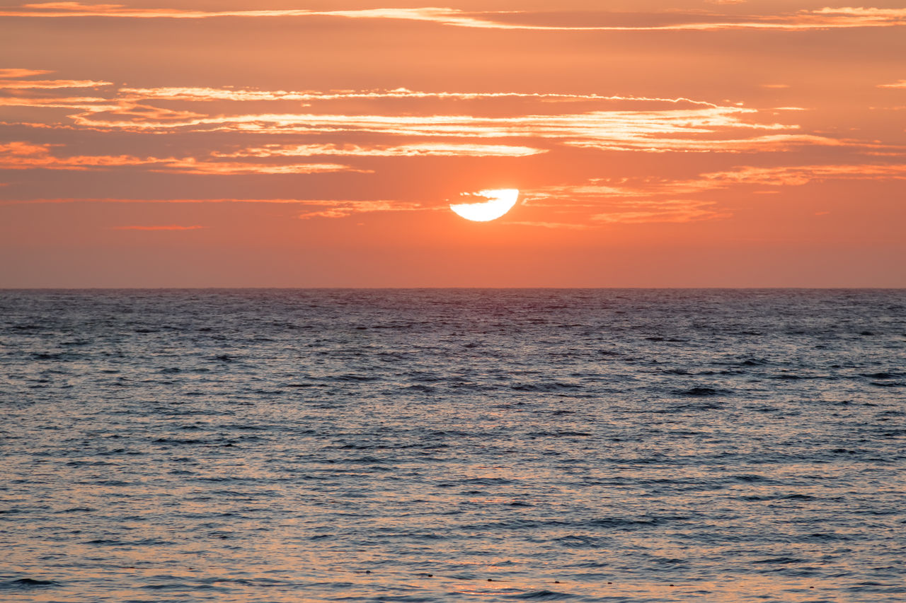 scenic view of sea against orange sky