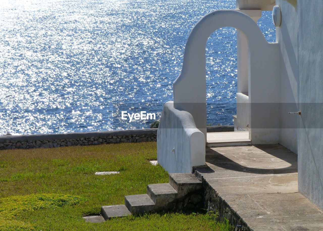 Whitewashed building by sea