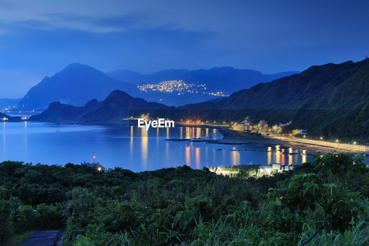 Scenic view of lake and mountains against sky