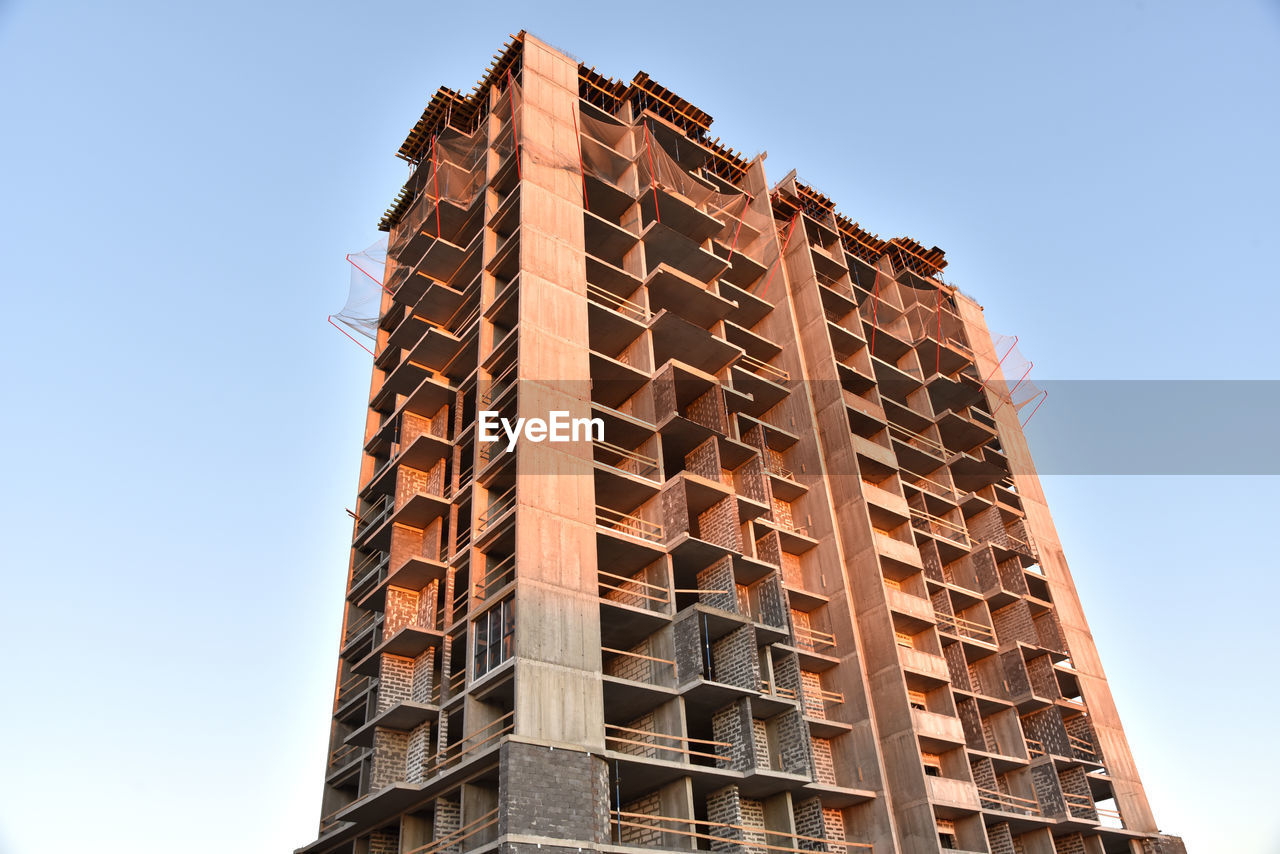 Construction the high-rise building. new residential skyscraper on blue sky background. 