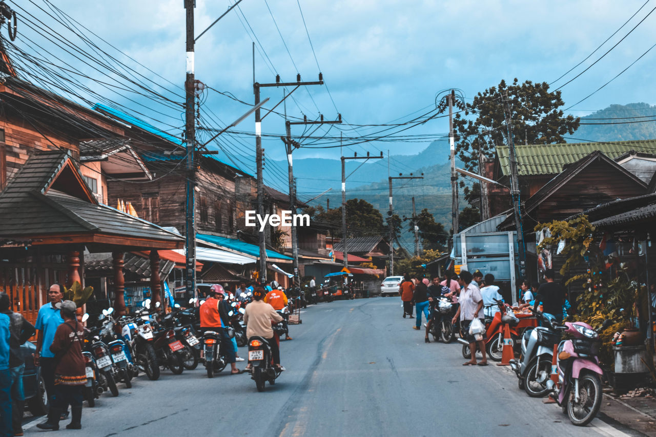 People and vehicles on street in city