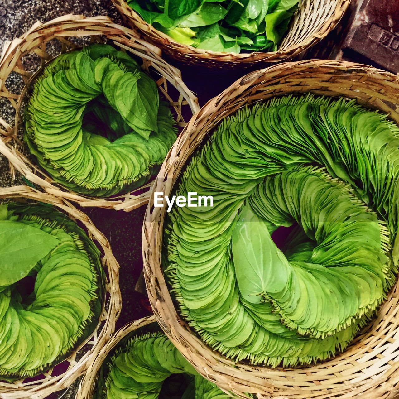 Directly above shot of betel leaves in whicker basket for sale