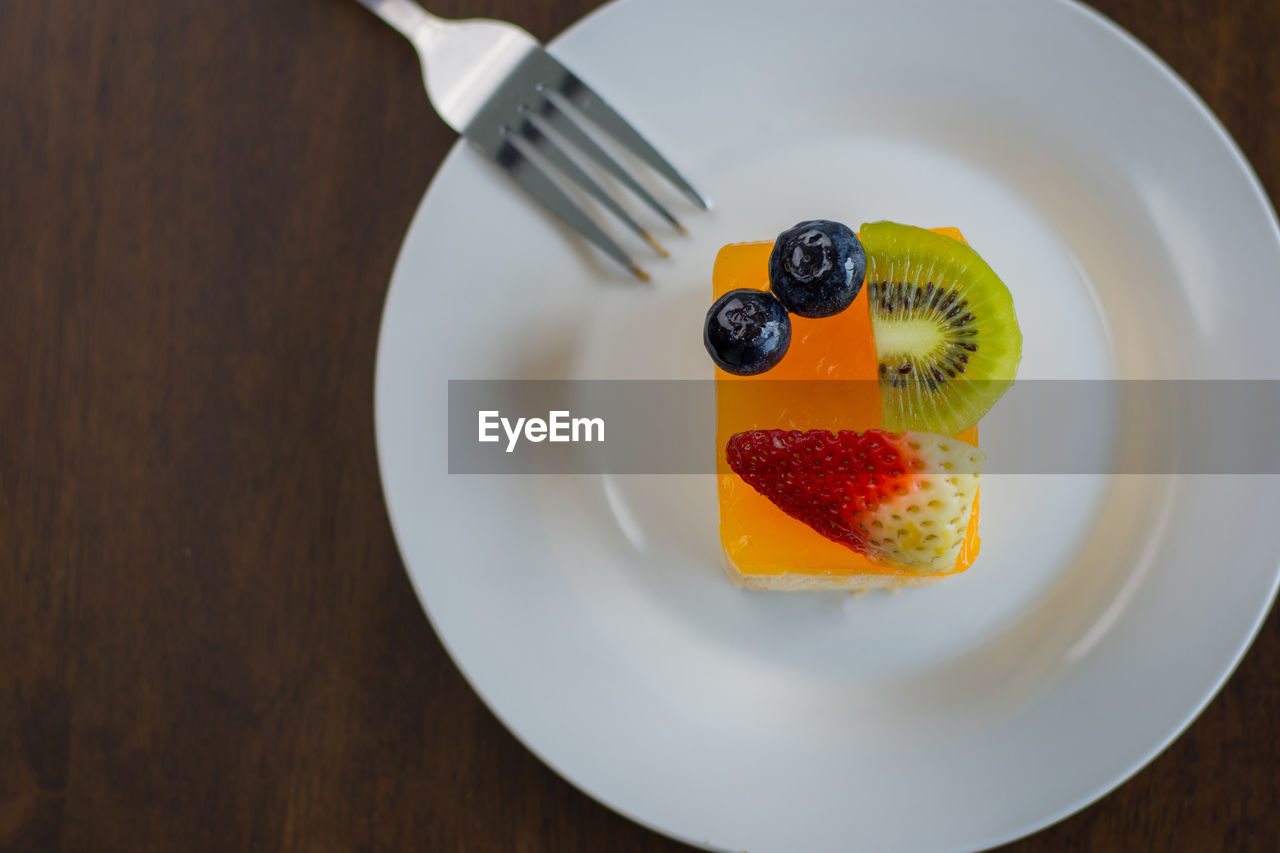 Orange cake is placed in a delightful white dish