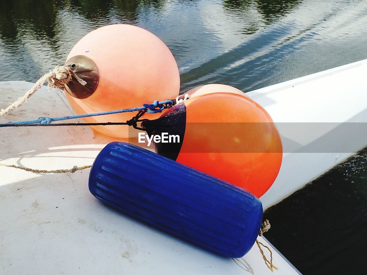 HIGH ANGLE VIEW OF PERSON IN BOAT MOORED ON SHORE