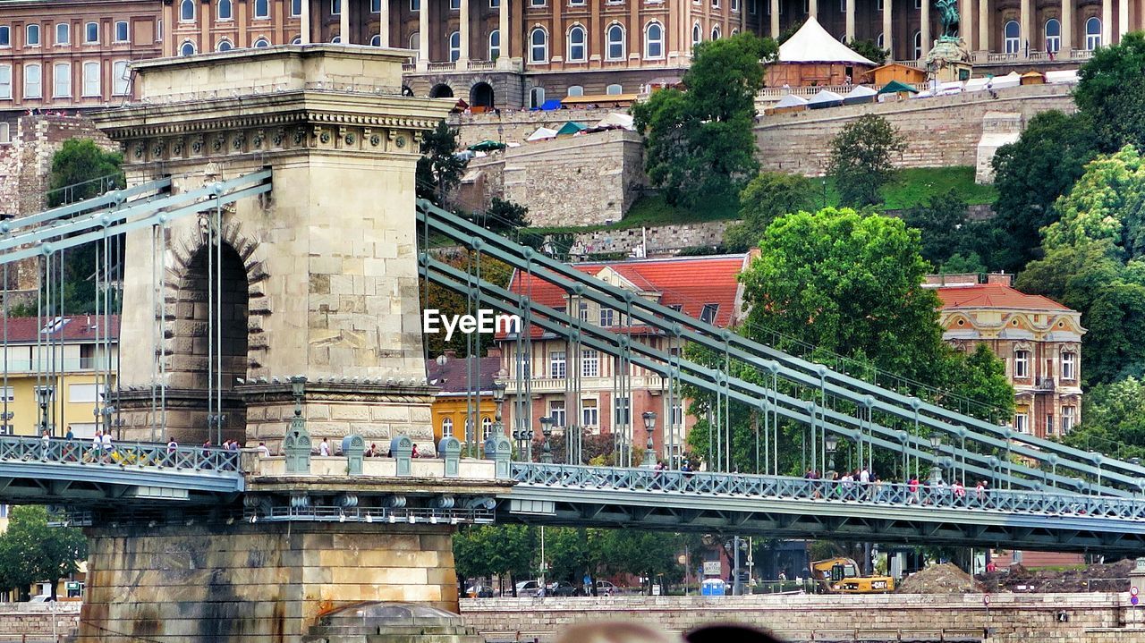 Chain bridge against buildings