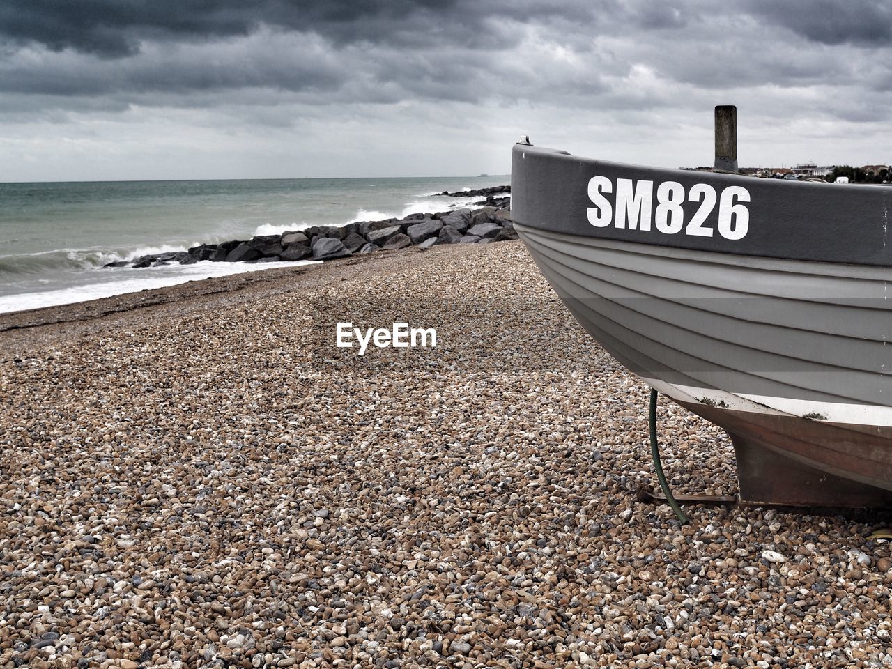 Information sign on beach against sky