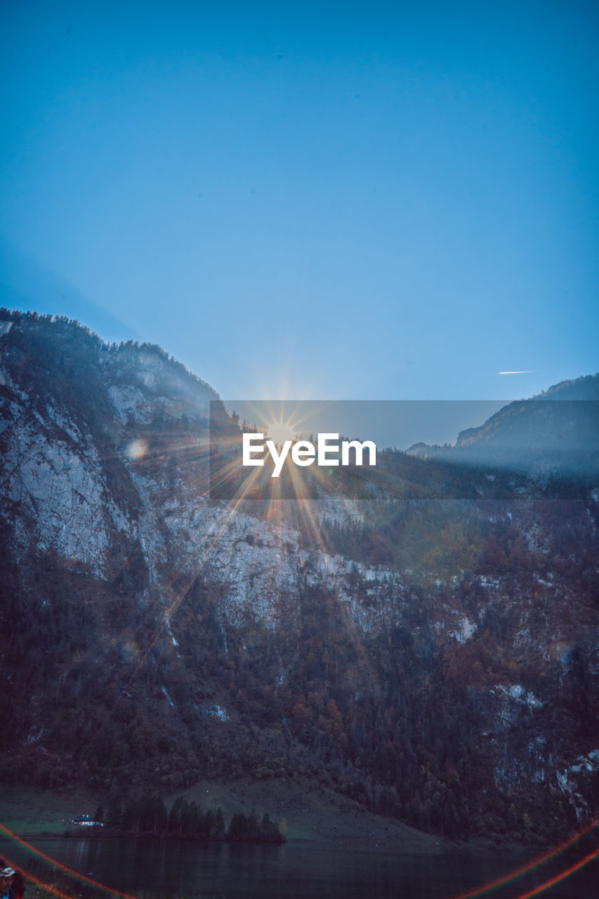 Scenic view of mountains against blue sky