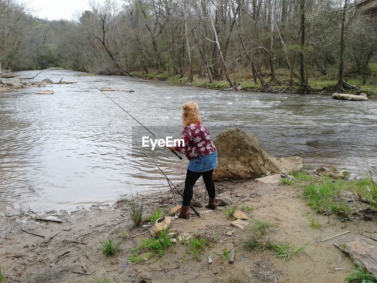 Full length of woman fishing at river
