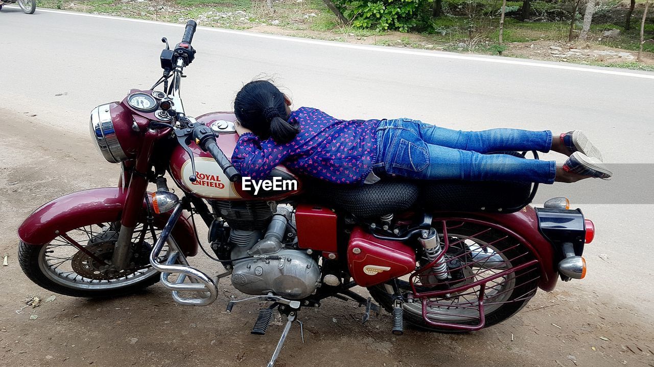 MAN RIDING MOTORCYCLE ON STREET