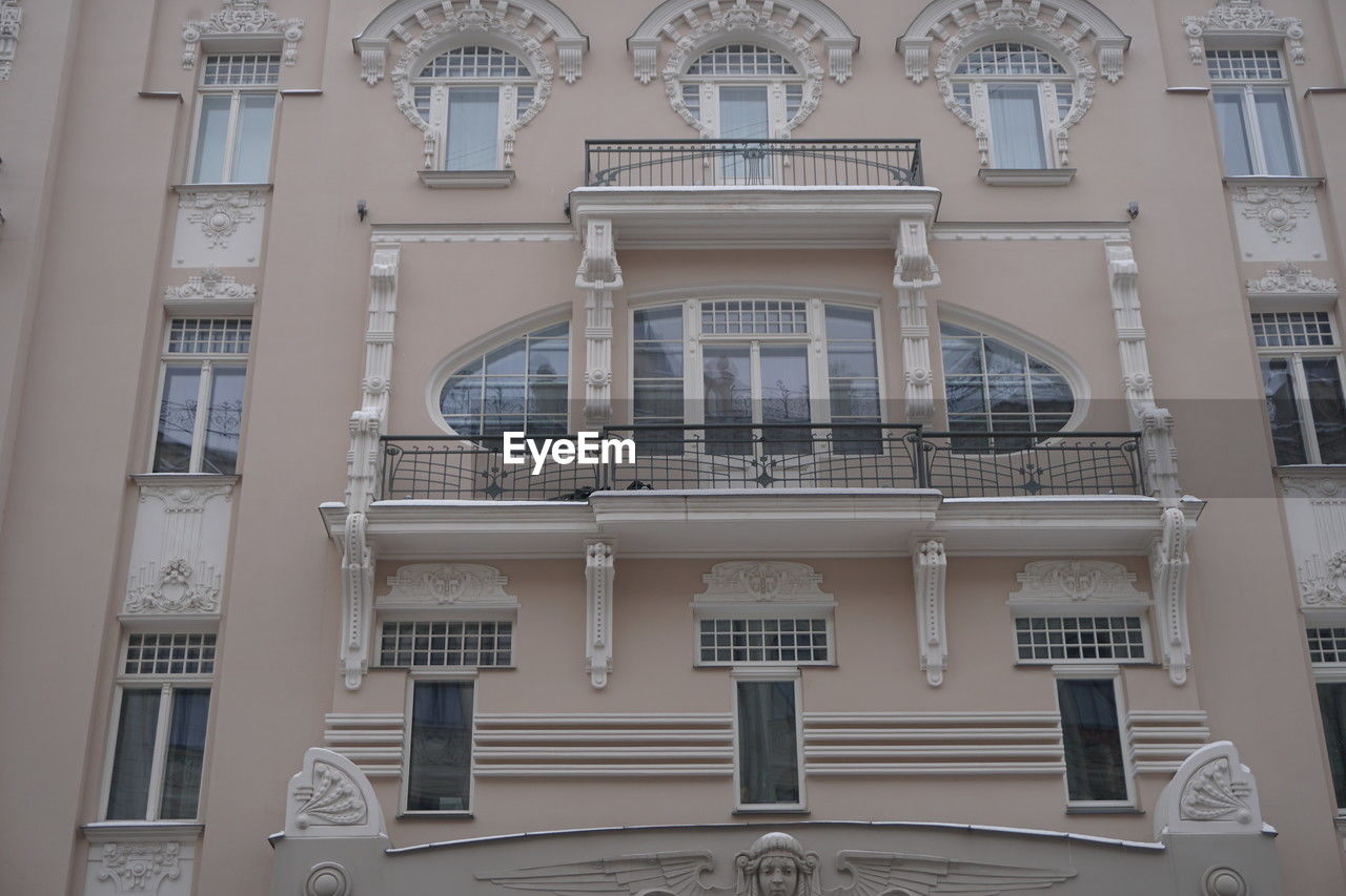 architecture, built structure, building exterior, facade, building, window, no people, low angle view, arch, day, residential district, outdoors, railing, city