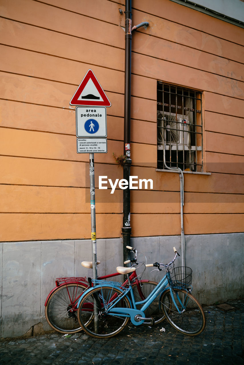 BICYCLE PARKED ON ROAD SIGN