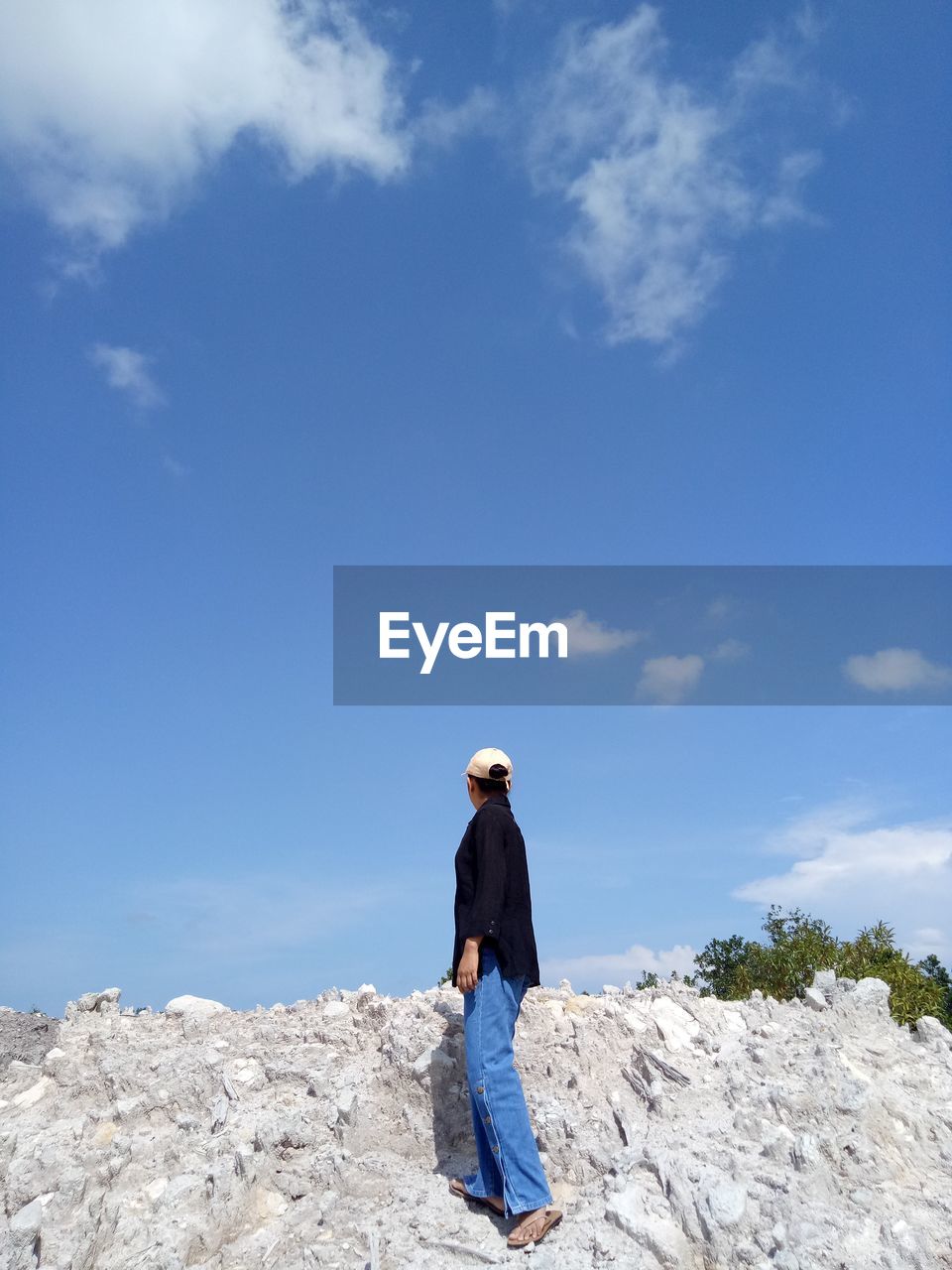 Woman standing on a pile of white sand