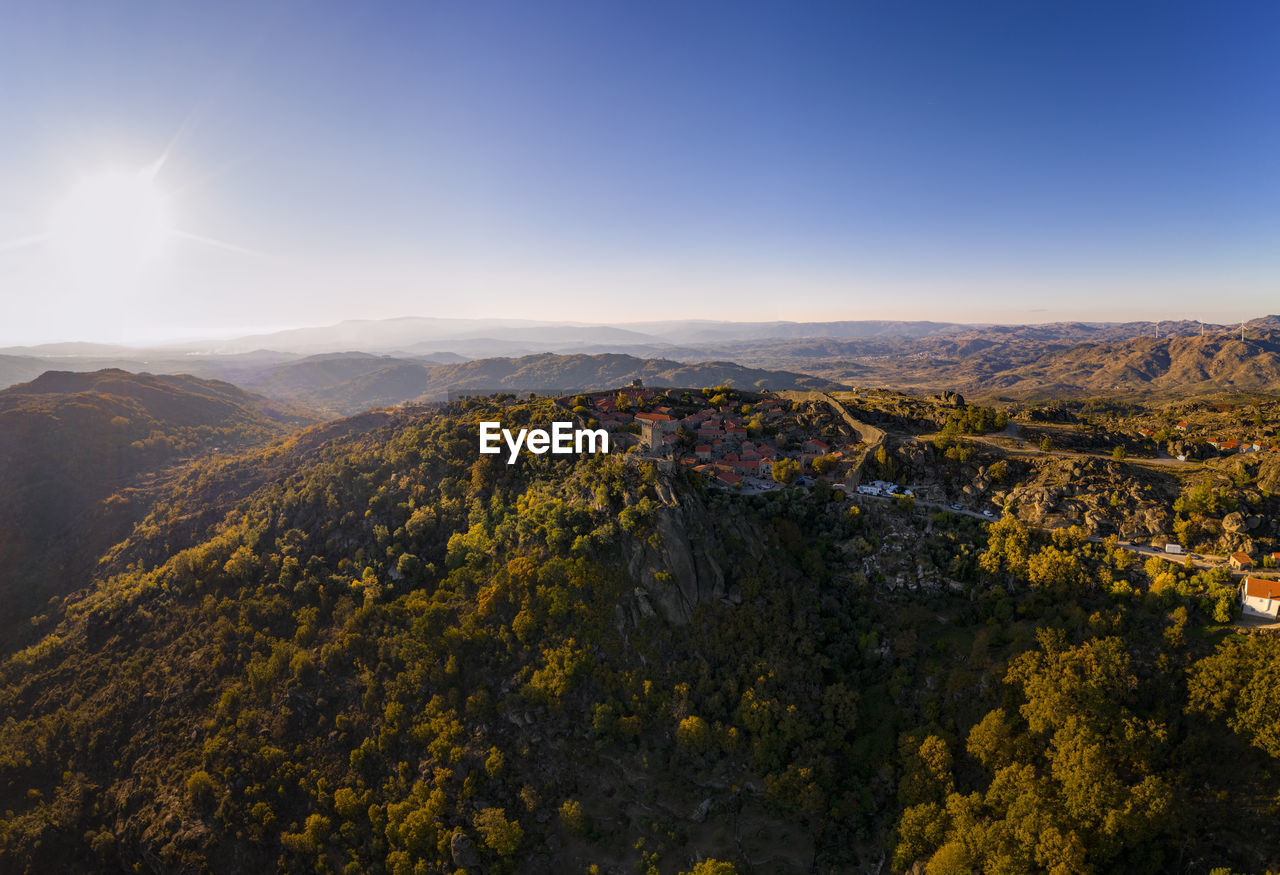 Drone aerial panorama of historic village of sortelha with castle and with turbines