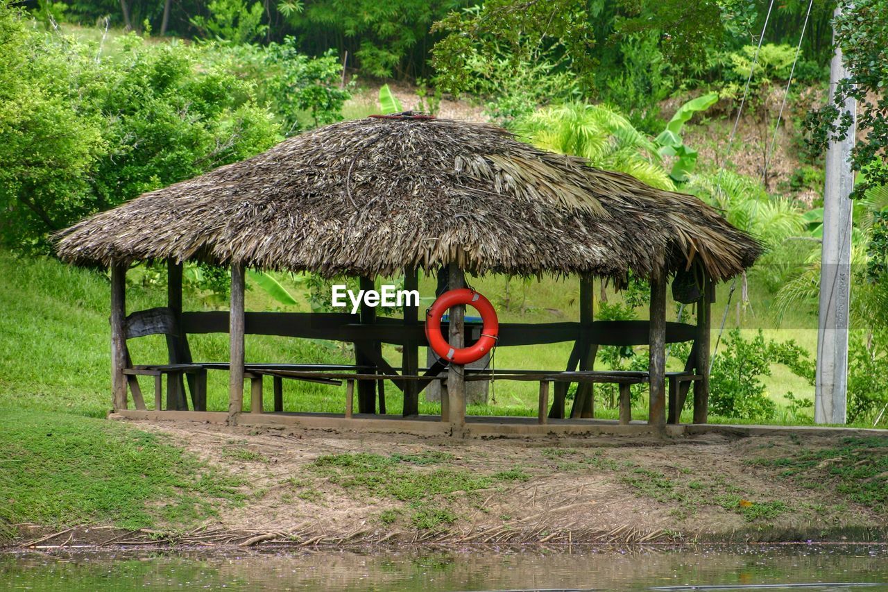 Thatched gazebo on field