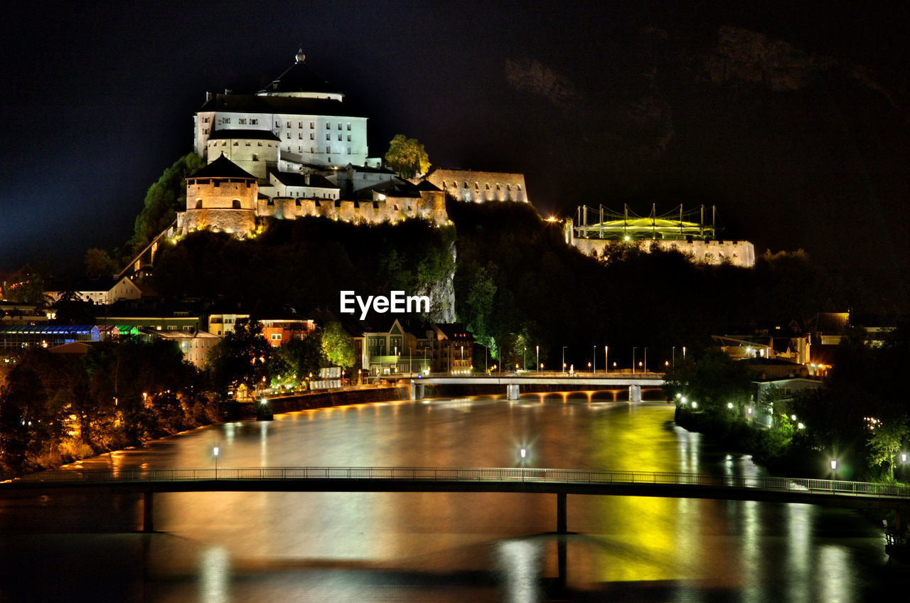 Illuminated kufstein fortress against sky at night