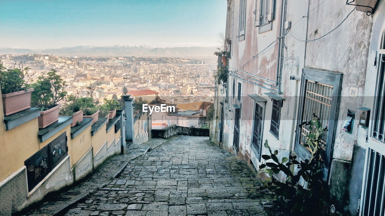 High angle view of footpath amidst buildings against cityscape