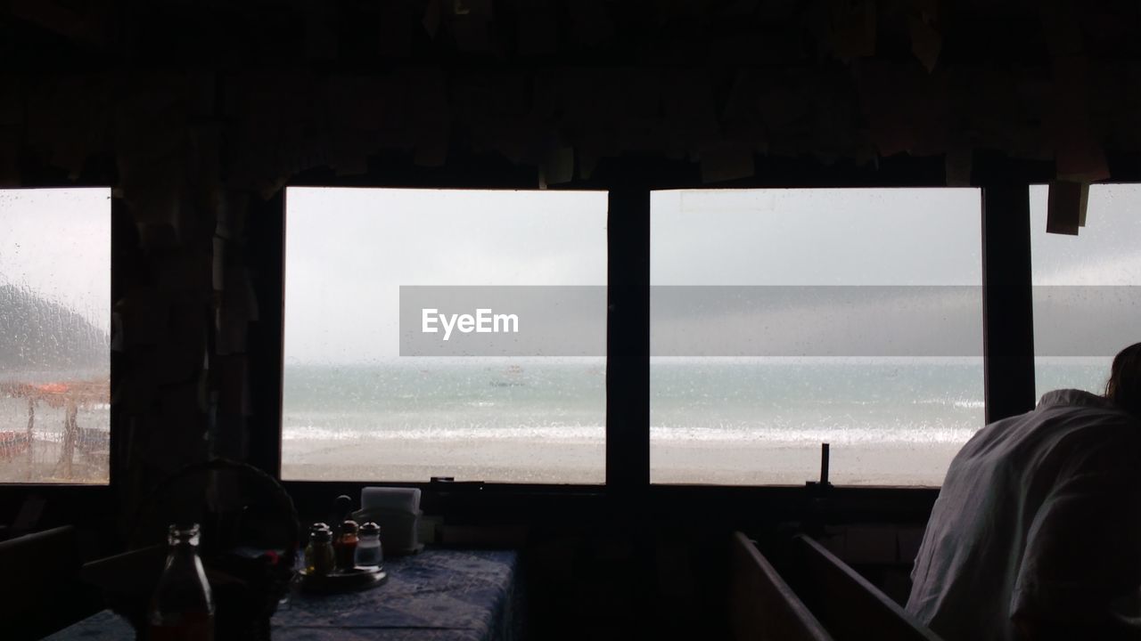 Scenic view of sea against sky seen through window