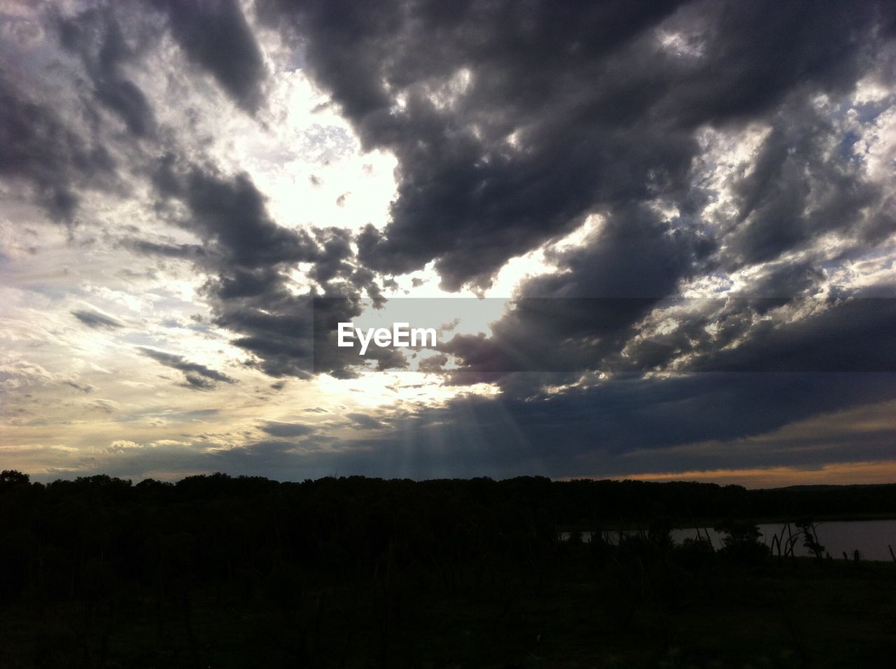 SCENIC VIEW OF LANDSCAPE AGAINST CLOUDY SKY DURING SUNSET