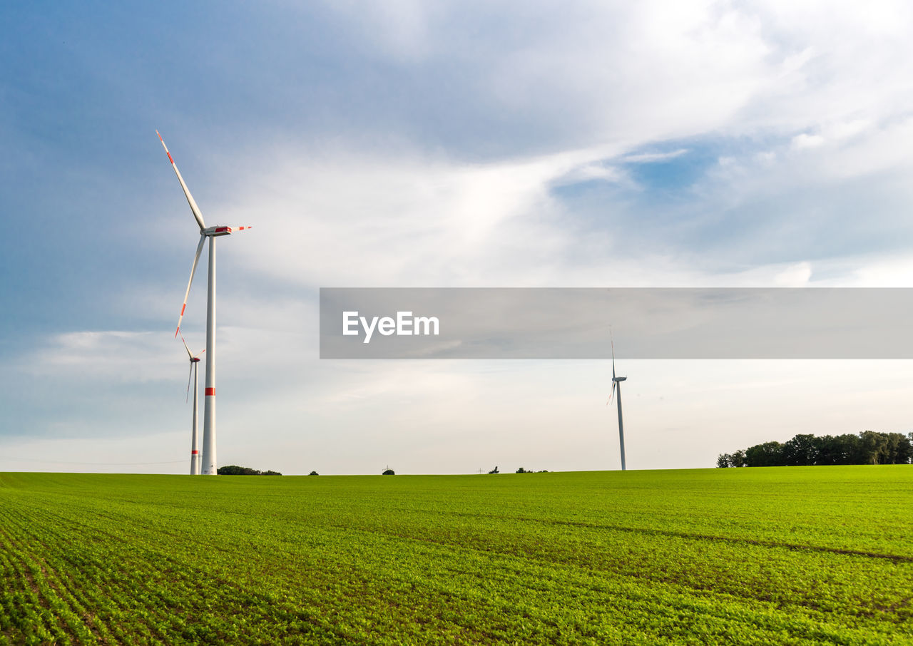 Windmill on field against sky