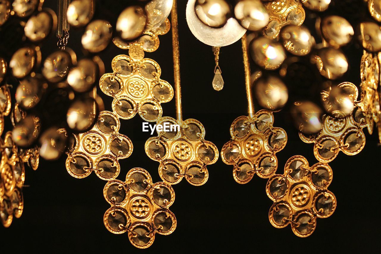 Close-up of illuminated chandelier on black background