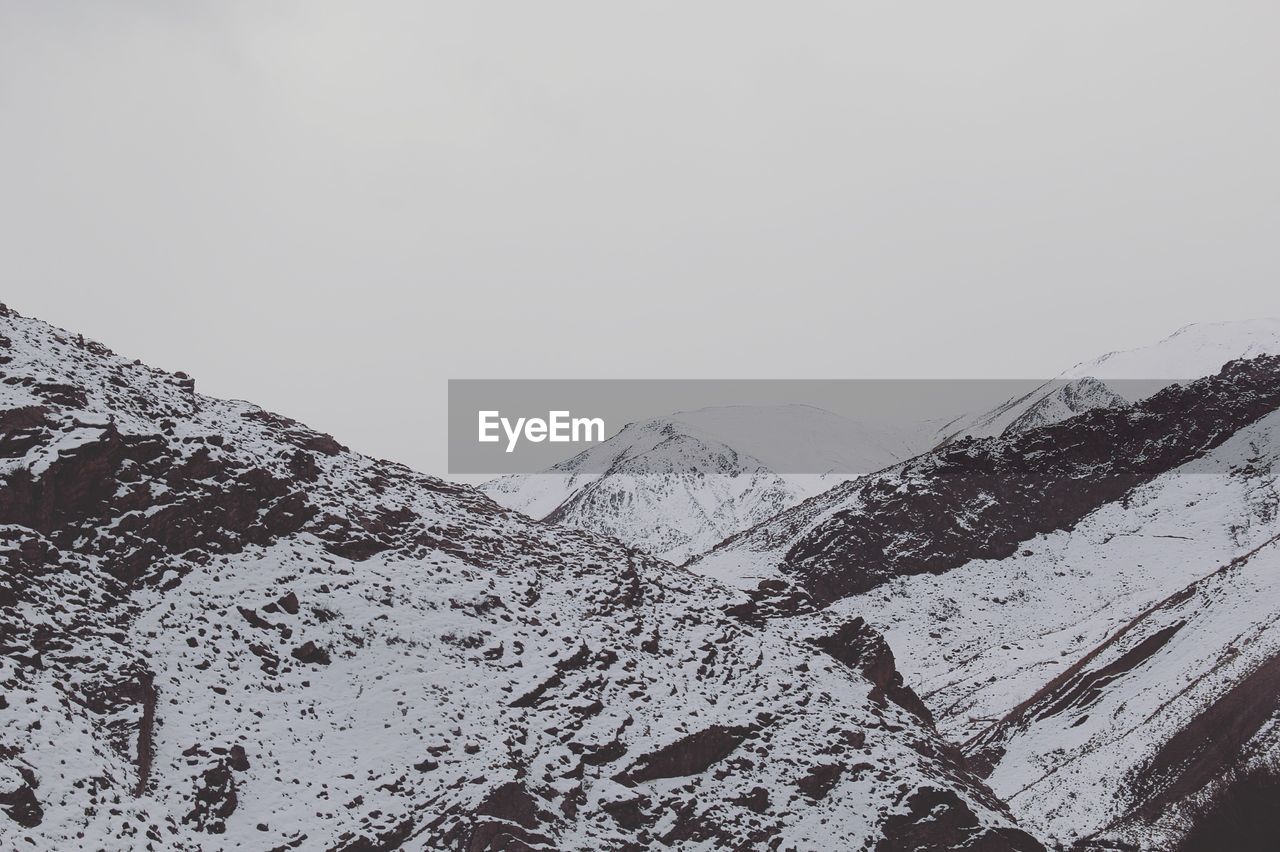 Scenic view of snow covered mountains against sky