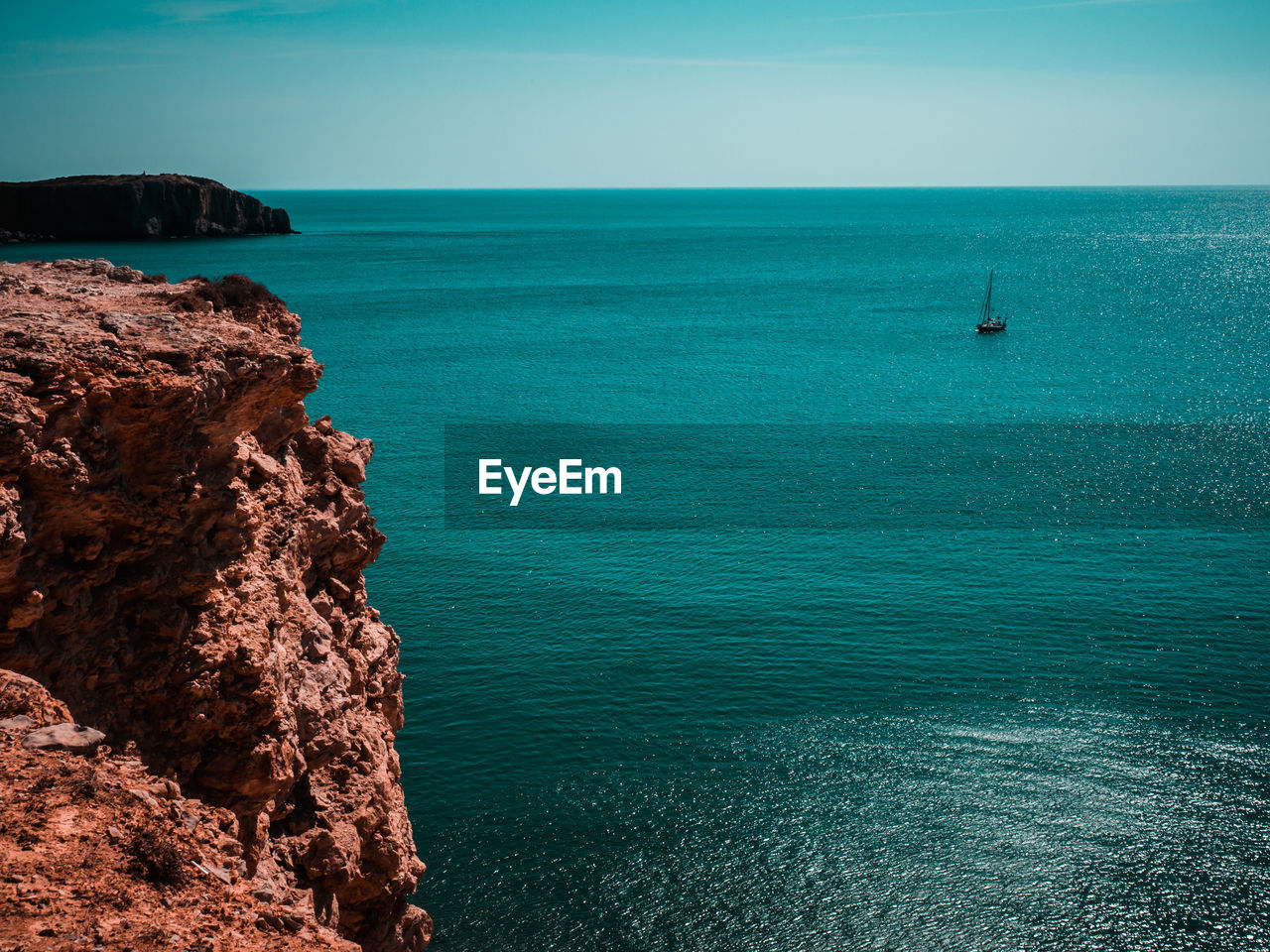 Scenic view of sea against blue sky