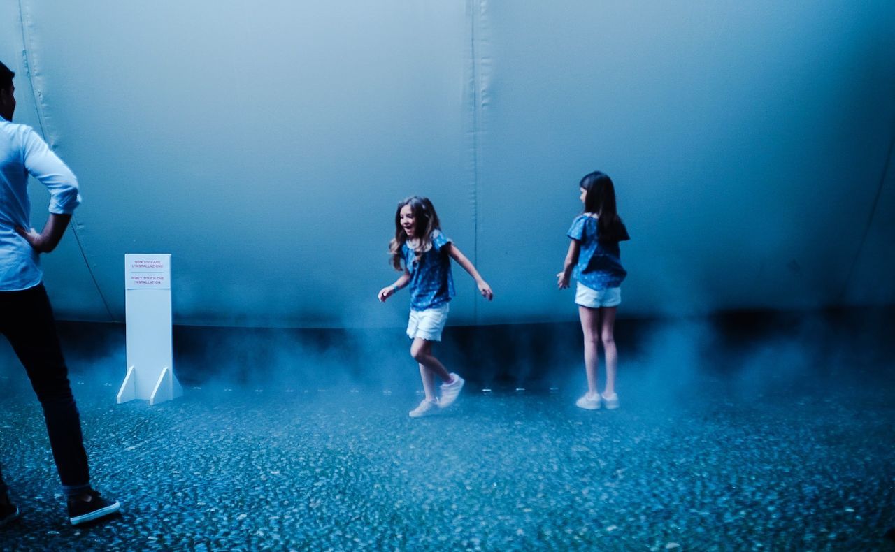 DIGITAL COMPOSITE IMAGE OF WOMEN STANDING AGAINST BLUE SKY