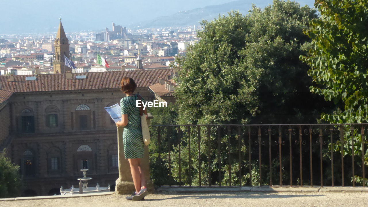 Rear view of woman against cityscape