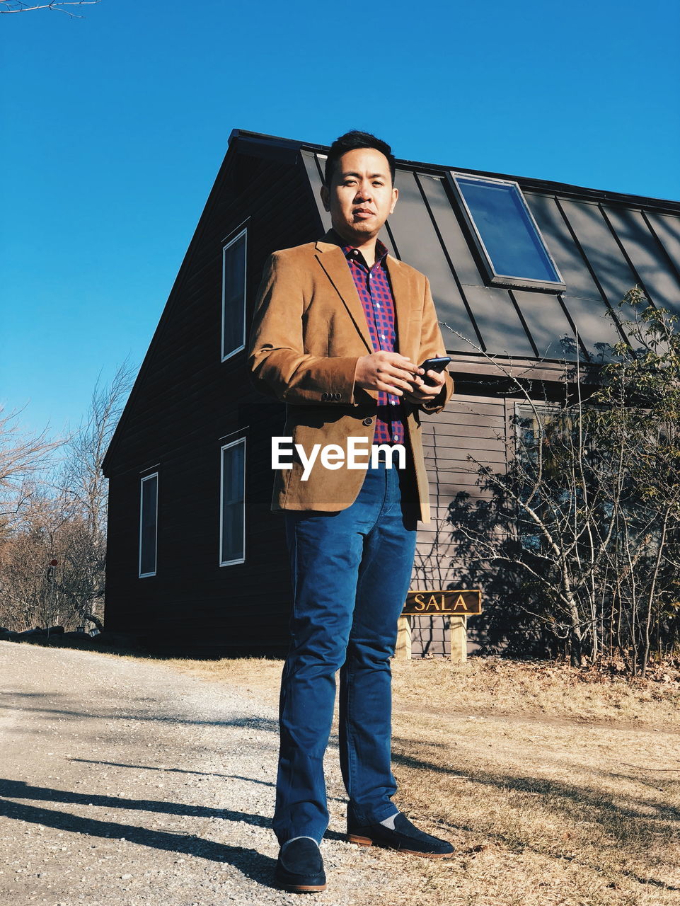 Low angle view of man standing against building