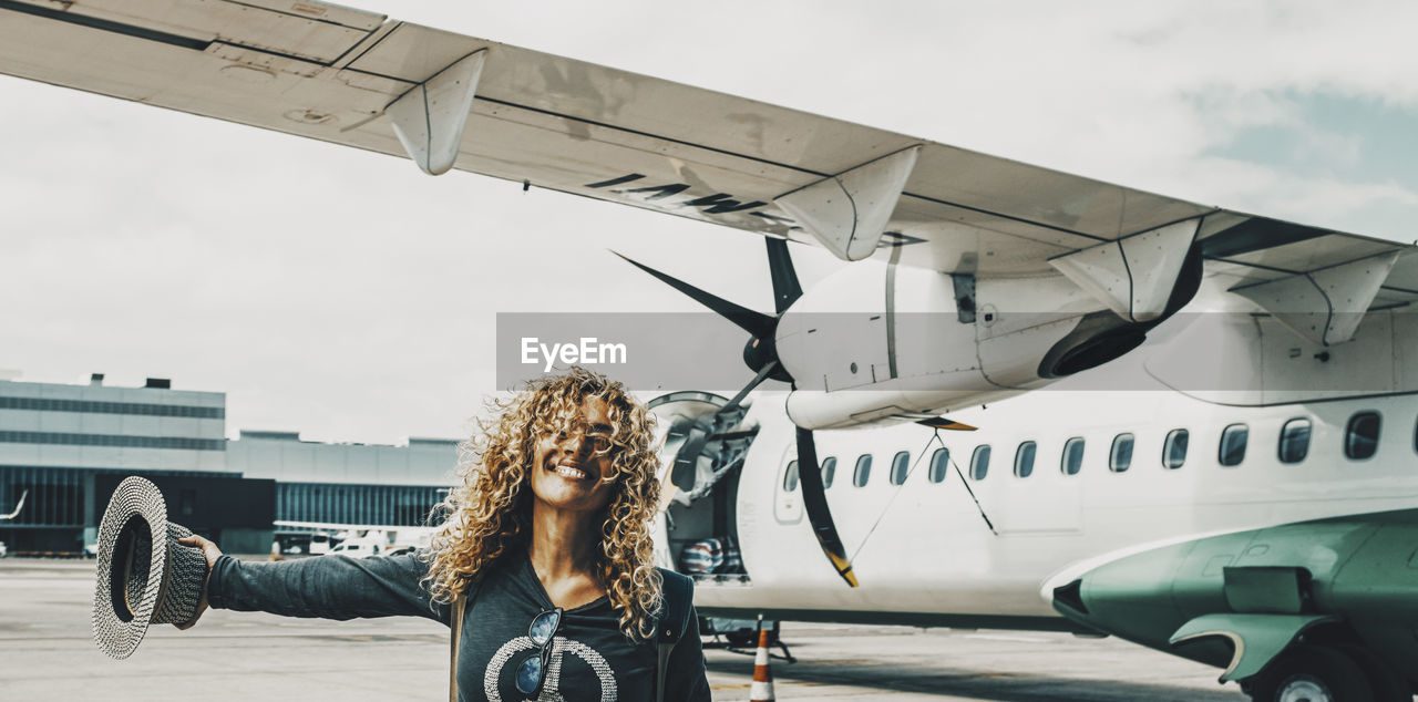 rear view of woman standing on airport runway