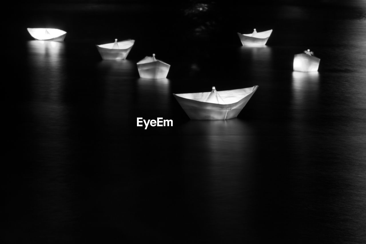 Close-up of illuminated paper boat in water