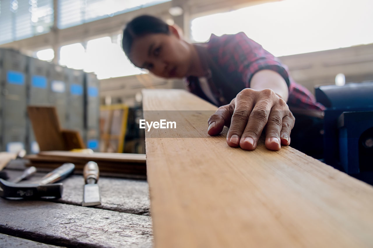 MAN WORKING ON WOOD