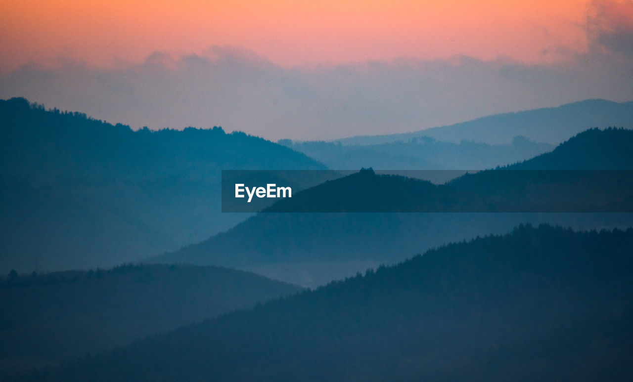 Scenic view of mountains against sky during sunset