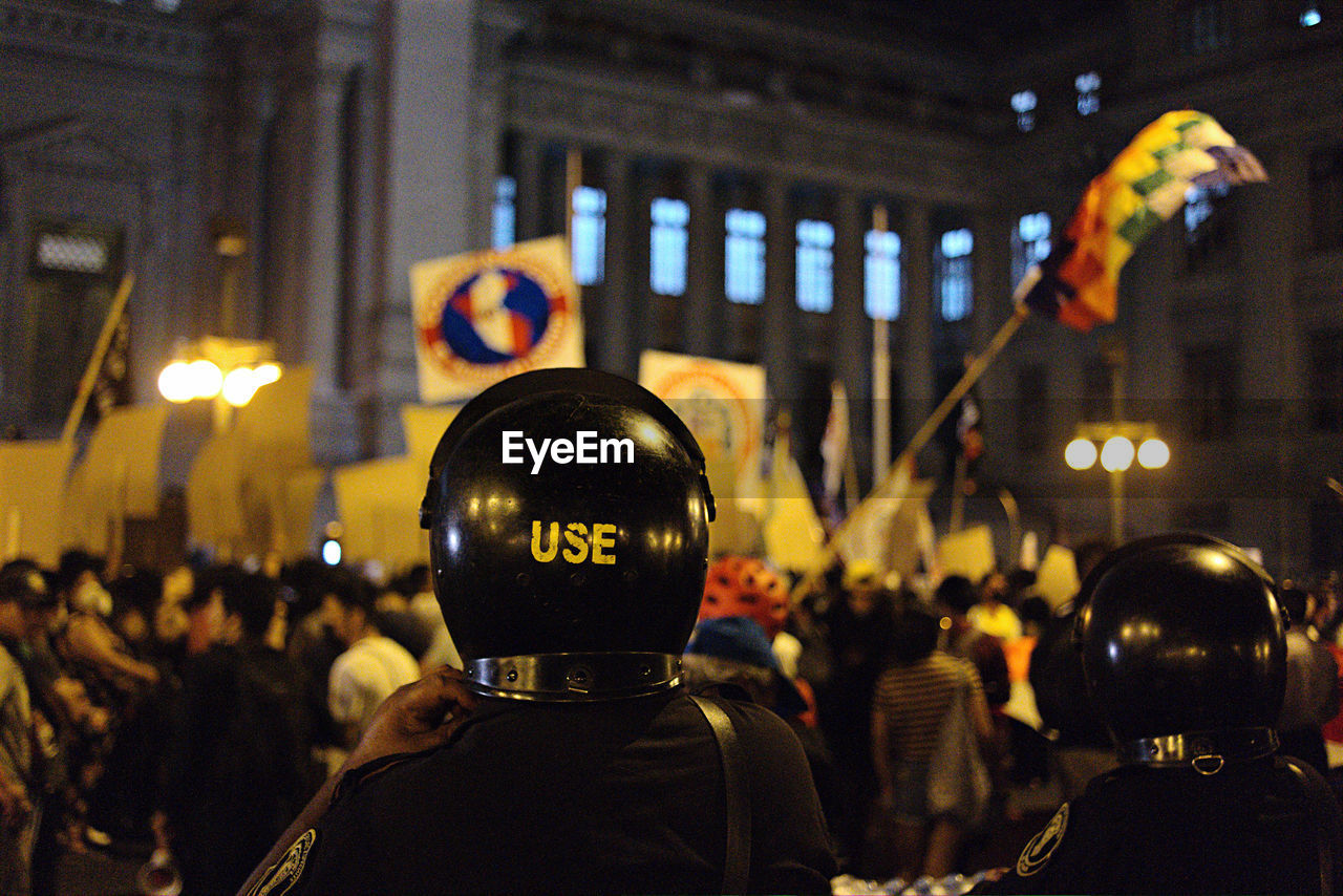 Rear view of police at night manifestation 
