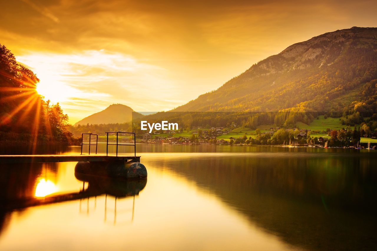 SCENIC VIEW OF LAKE AGAINST ORANGE SKY