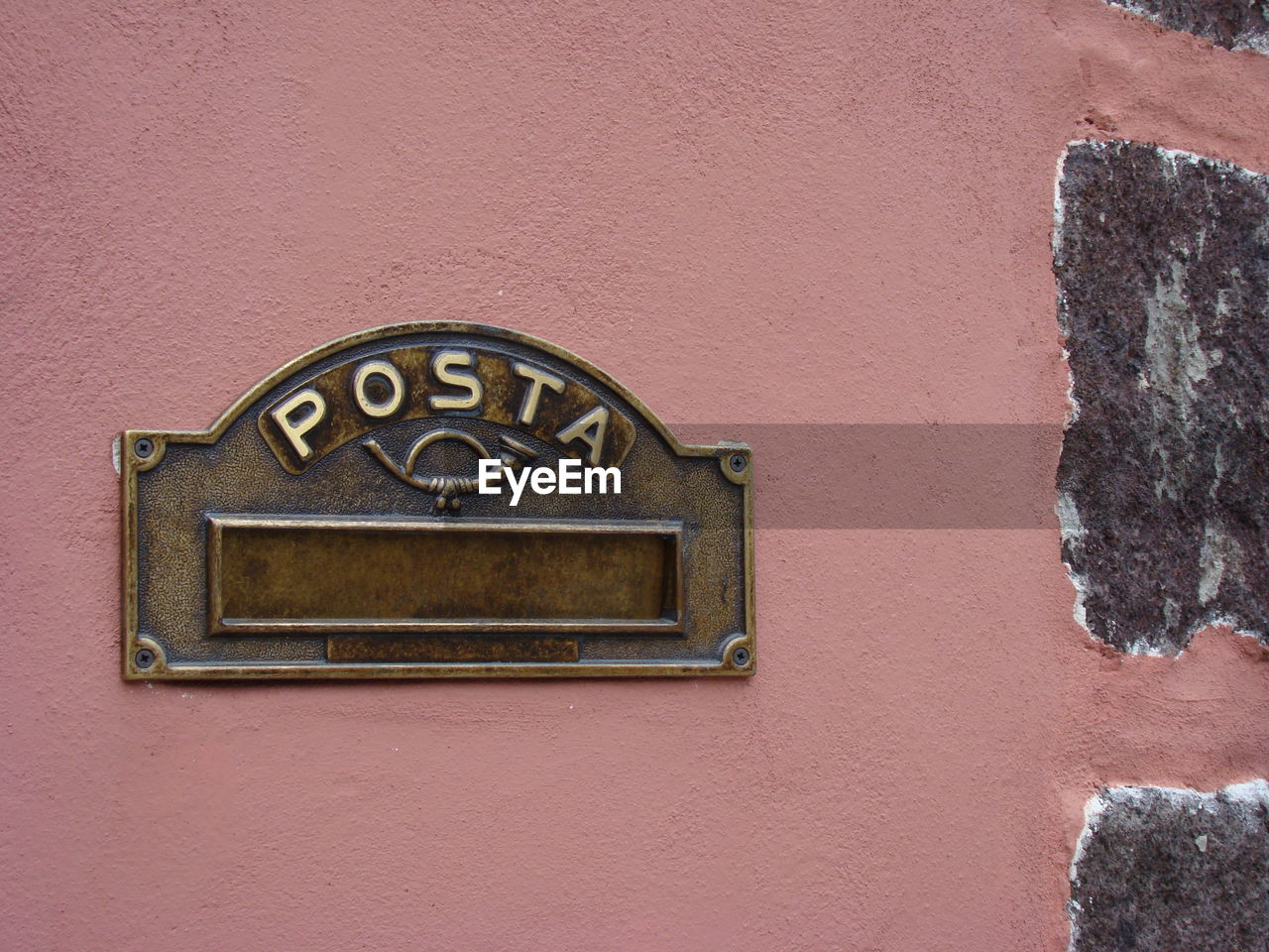 Close-up of metallic mail slot on wall