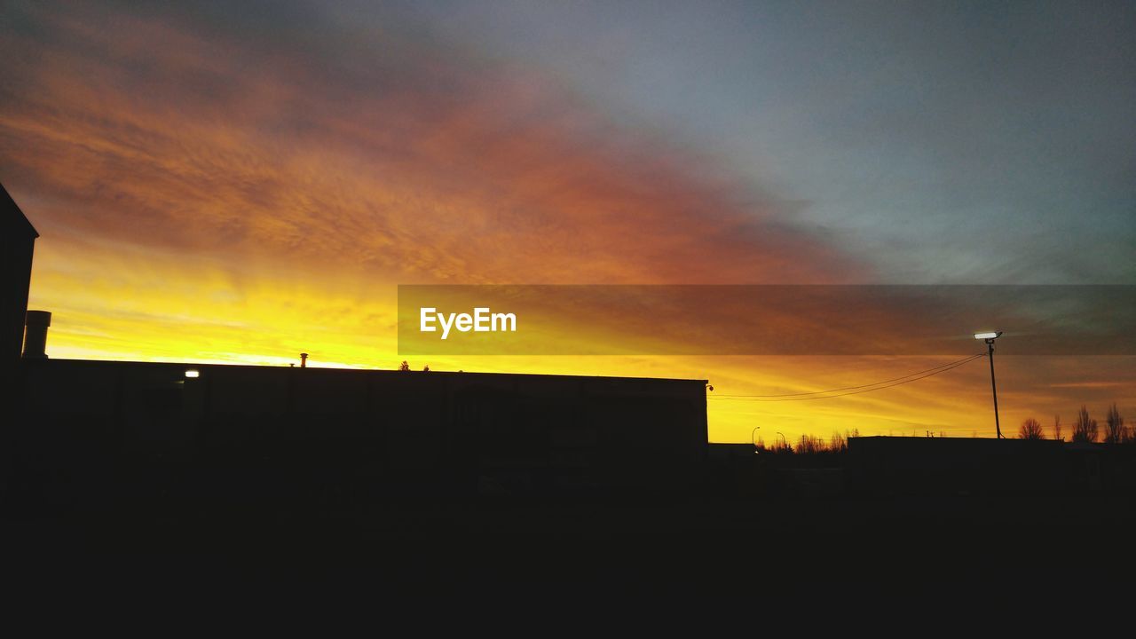 SILHOUETTE OF BUILT STRUCTURE AT SUNSET