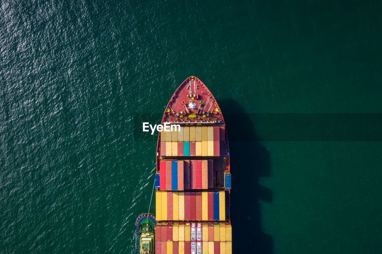 HIGH ANGLE VIEW OF BUILDING BY SEA