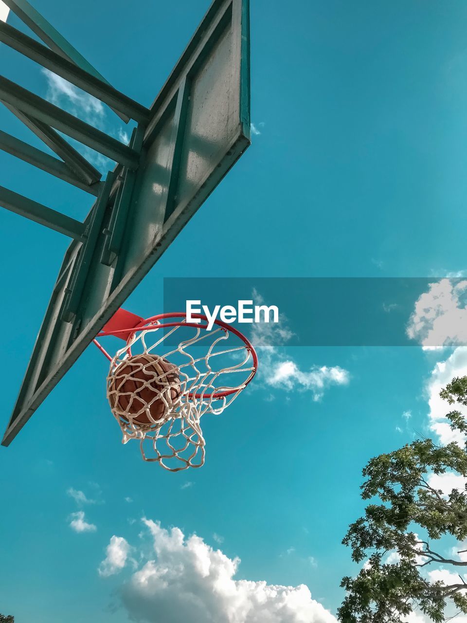 Low angle view of basketball hoop against blue sky