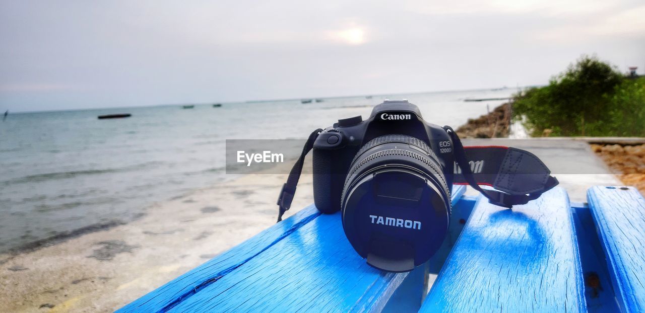 CLOSE-UP OF CAMERA ON BEACH