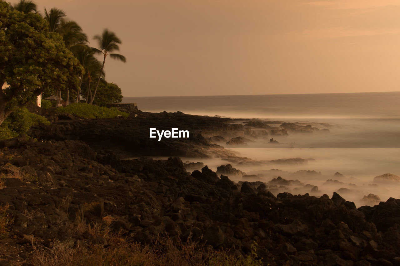 SCENIC VIEW OF BEACH DURING SUNSET