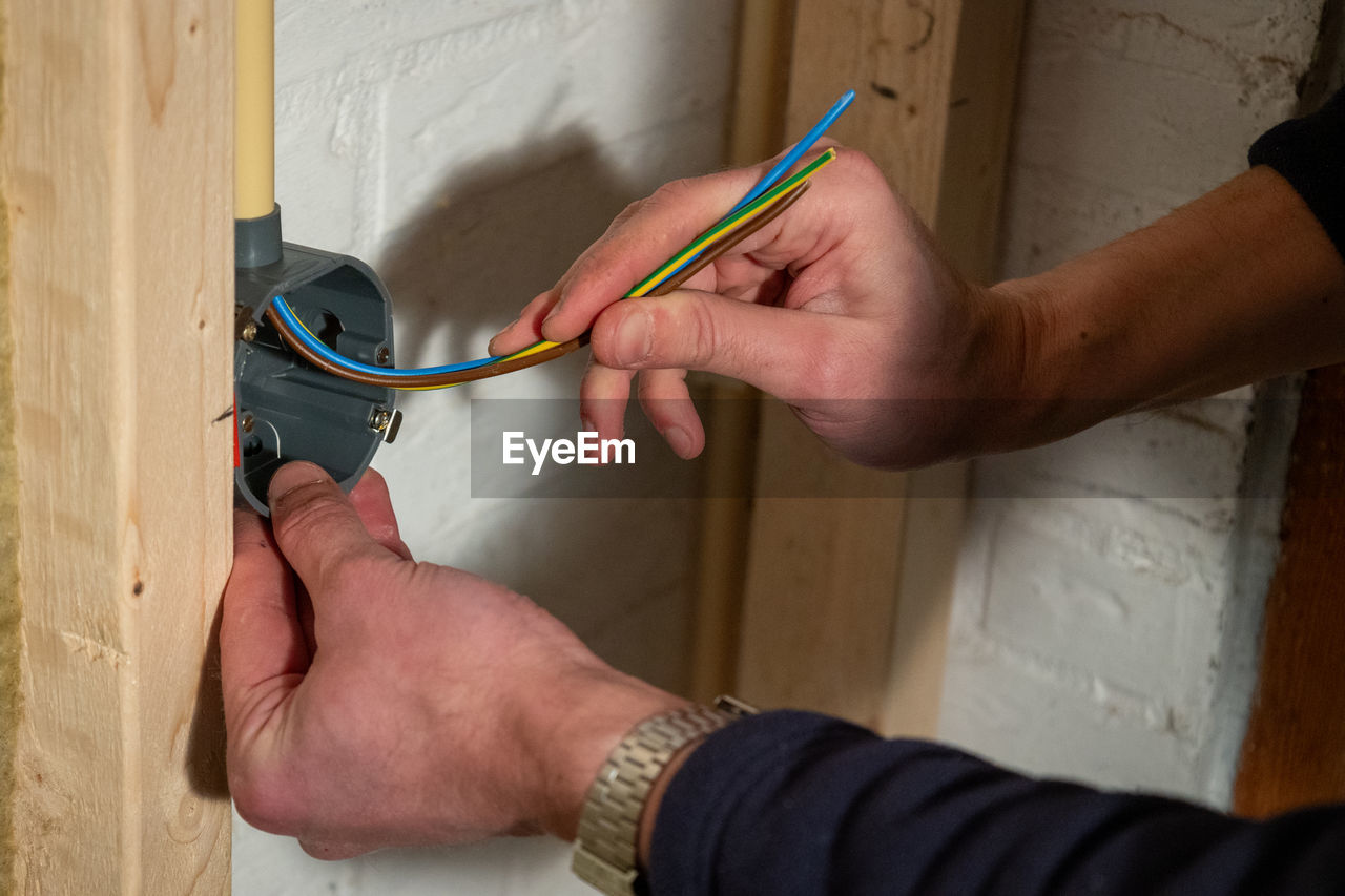 Installing electrical wiring with the brown phase, the blue neutral and the yellow earth wire